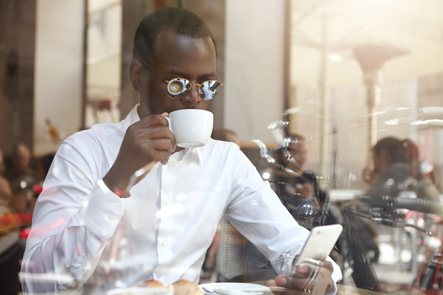 A man checking his emails in a cafe